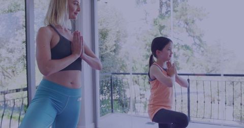 Mother and Daughter Practicing Yoga at Home in Harmony