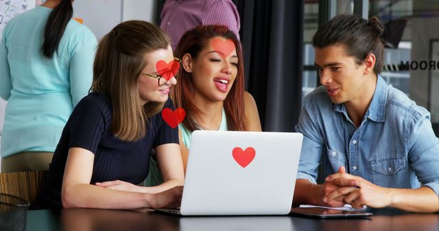 Group of friends laughing at online content with heart stickers - Download Free Stock Images Pikwizard.com