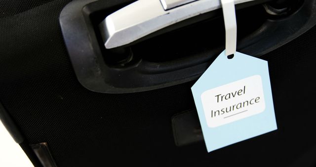 A travel insurance tag is attached to a suitcase handle, emphasizing the importance of securing coverage for trips. Travel insurance provides peace of mind by protecting against unforeseen events during journeys.