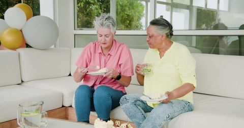 Senior Lesbian Couple Enjoying Birthday Celebration at Party