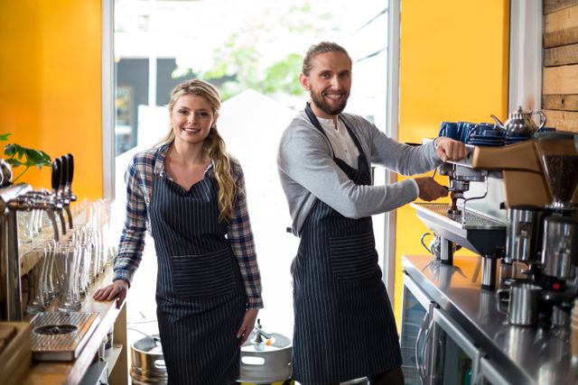 Smiling Barista and Waitress at Coffee Machine in Café - Download Free Stock Images Pikwizard.com