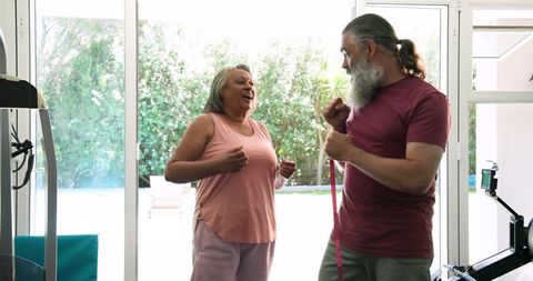 Senior Couple Exercising at Home Enjoying Active Lifestyle