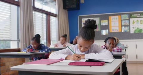 Young Students Focused on Classroom Writing Activity