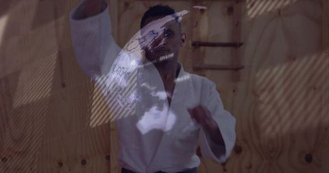 Striking martial artist wearing white gi and black belt with holographic globe overlay