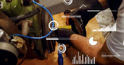 Technician adjusting flywheel with digital diagnostic overlays on industrial workbench