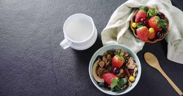 Healthy breakfast setup with fresh fruits like strawberries and grapes alongside milk, cereal, and granola. It can be used for nutrition, health, diet plans, lifestyle articles, food blogs, and wholesome eating campaigns.