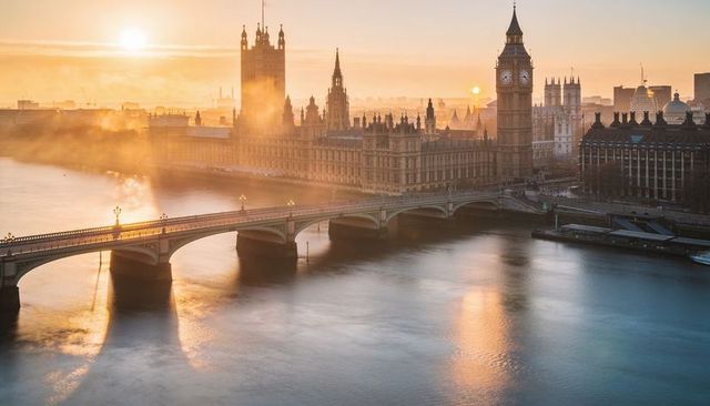 Golden sunrise over palace of westminster and big ben with mist on river thames