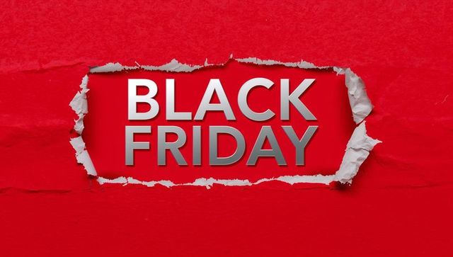Torn red paper revealing black friday metallic 3d text