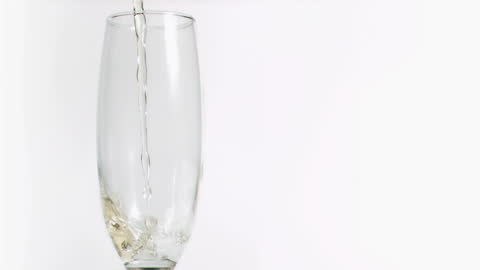 Champagne Pouring Elegantly into Flute with Minimalist Background