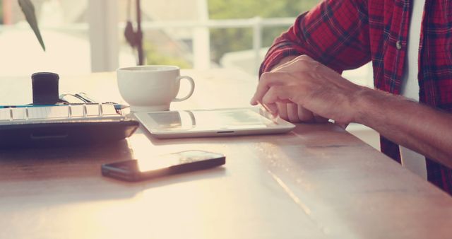 Man Working on Digital Tablet at Home Office Desk with Coffee and Smartphone - Download Free Stock Images Pikwizard.com