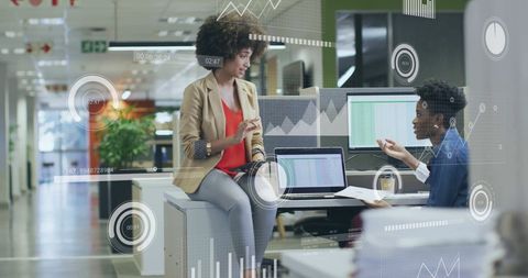 Diverse Colleagues Discussing Work with Digital Financial Data Interface