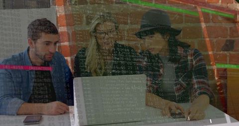 Tech team collaborating on laptop with code overlay during coworking debugging session