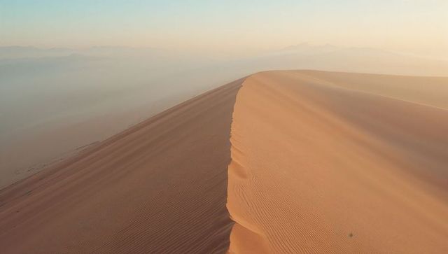 Majestic sand dune ridge at sunrise in arid desert