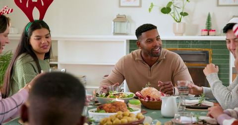 Diverse Friends Celebrating with Holiday Dinner at Cozy Home