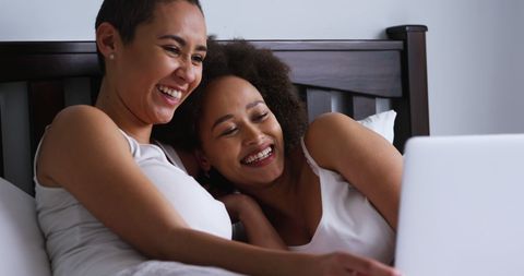 Happy Lesbian Couple Relaxing on Bed Using Laptop - Download Free Stock Images Pikwizard.com