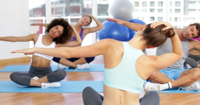 Group Yoga Class with Stretching Exercises in Bright Studio - Download Free Stock Images Pikwizard.com