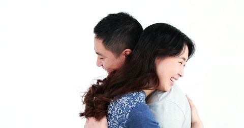 Young Asian Couple Embracing with Joyful Smiles