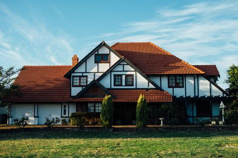 Picturesque Tudor-Style House with Red Roof at Sunset