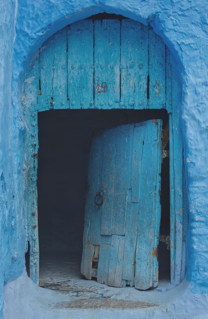 Rustic weathered blue doorway suggests cultural history, ideal for themes highlighting traditional Mediterranean architecture or vintage travel experiences. Use in blogs about historical explorations or cultural heritage promotion.