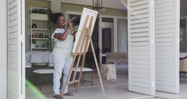 Woman Painting on Canvas in Home Studio with Open Doors - Download Free Stock Images Pikwizard.com