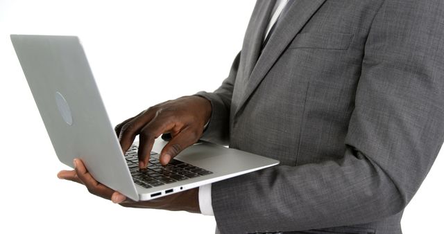 Business Professional Typing on Laptop in Gray Suit - Download Free Stock Images Pikwizard.com