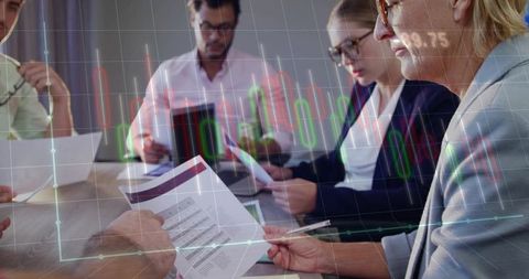 Boardroom Team Analyzing Financial Reports with Candlestick Market Charts for Strategy