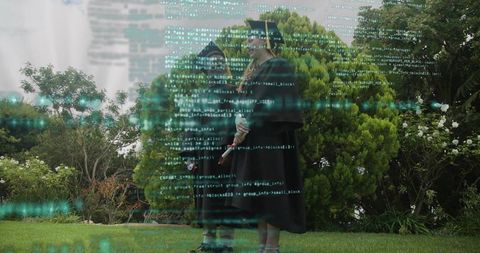 Graduation pair standing in garden in caps and gowns holding diplomas with code overlay