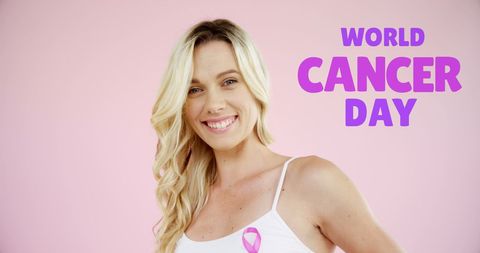 World cancer day awareness: smiling woman on pink background