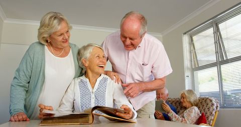 Senior friends enjoying sharing memories in nursing home
