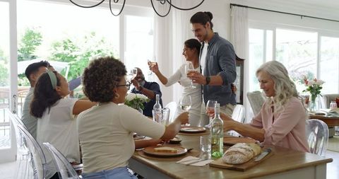 Celebration Gathering with Friends and Family Toasting at Table