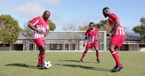 Energetic Male Soccer Players Training on a sunny day