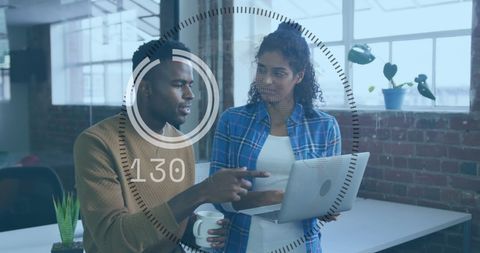 Diverse Professionals Analyzing Data on Laptop