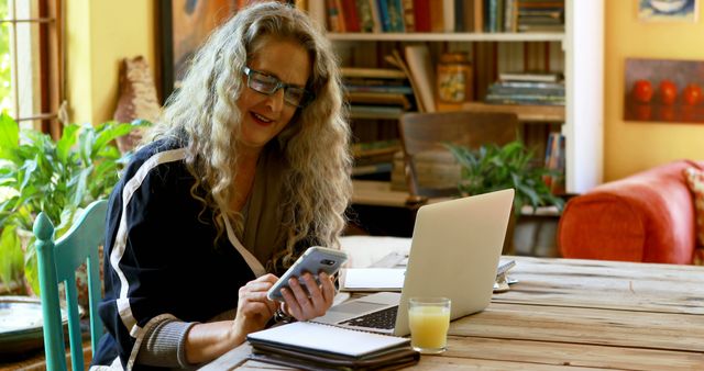 Senior Woman Working from Home Using Laptop and Smartphone - Download Free Stock Images Pikwizard.com