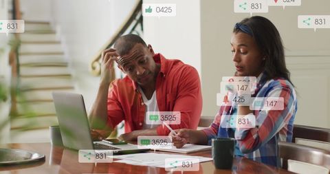 Couple managing finances surrounded by social media elements