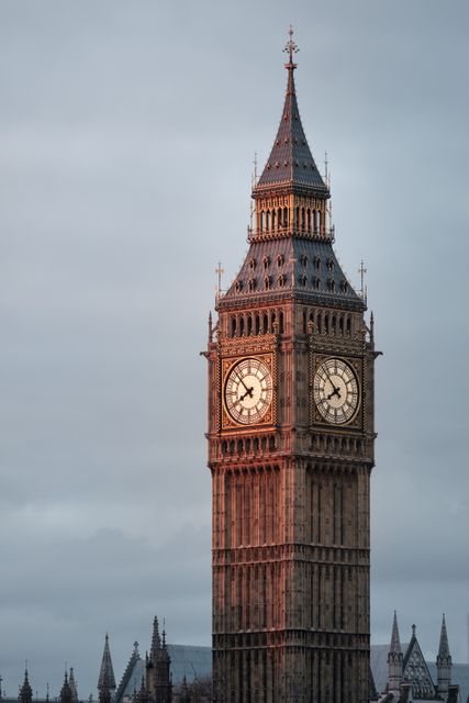 Big Ben in London captured during sunset, highlighting intricate architectural details. Perfect for promoting UK tourism, architectural studies, travel guides, postcards, and historical presentations.