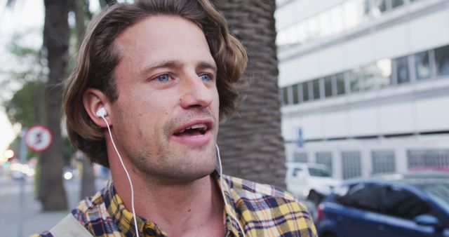 Casual Man Listening to Music and Singing on City Street - Download Free Stock Images Pikwizard.com