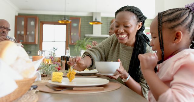 African american parents, children and grandparents celebrating at thanksgiving dinner, slow motion. Thanksgiving, celebration, meal, home, family, togetherness, unaltered.