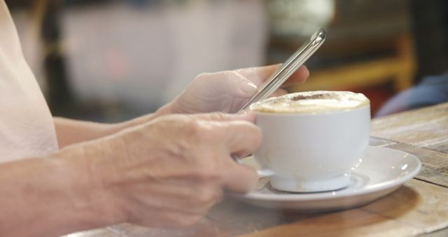 Person Using Smartphone While Enjoying Coffee in Cafe - Download Free Stock Images Pikwizard.com