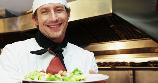 Smiling Chef Presenting Gourmet Dish in Professional Kitchen - Download Free Stock Images Pikwizard.com