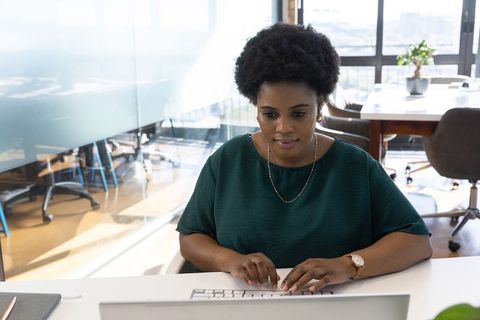 Focused Professional African American Woman Working in Modern Office