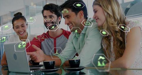 Diverse Team Collaborating on Laptop with Augmented Green Energy, Sustainability and Tech Icons