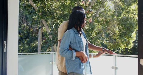 Romantic Couple Embracing on Modern Home Balcony