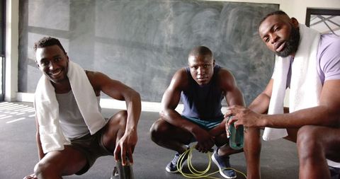 Athletic Men Resting Together After Workout