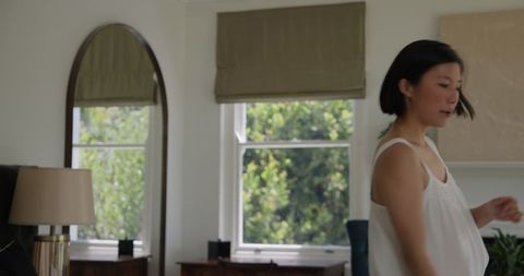 Woman Undertaking Household Chores in Modern Living Room