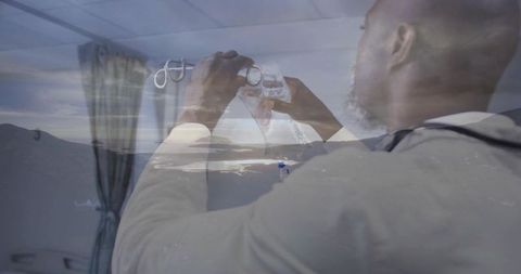 Medical professional adjusting respirator mask double exposure mountain lake landscape