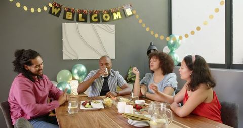 Diverse Friends Celebrating with Toast in Living Room Party