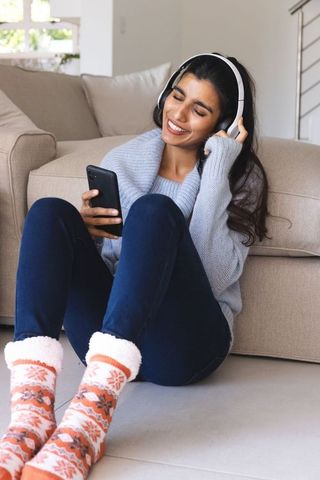 Joyful Woman Relaxing with Headphones Enjoying Music