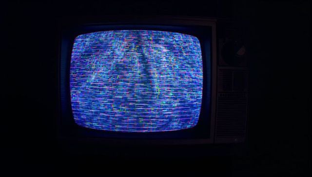 Retro Flickering CRT Television Displaying Static in Darkness