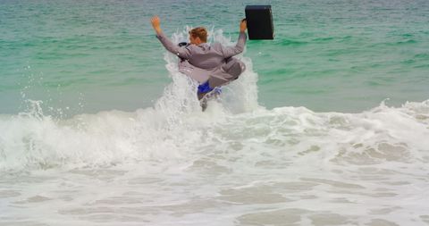 Businessman embracing waves with briefcase