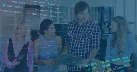 Startup team collaborating over laptop with stock market data overlay and analytics